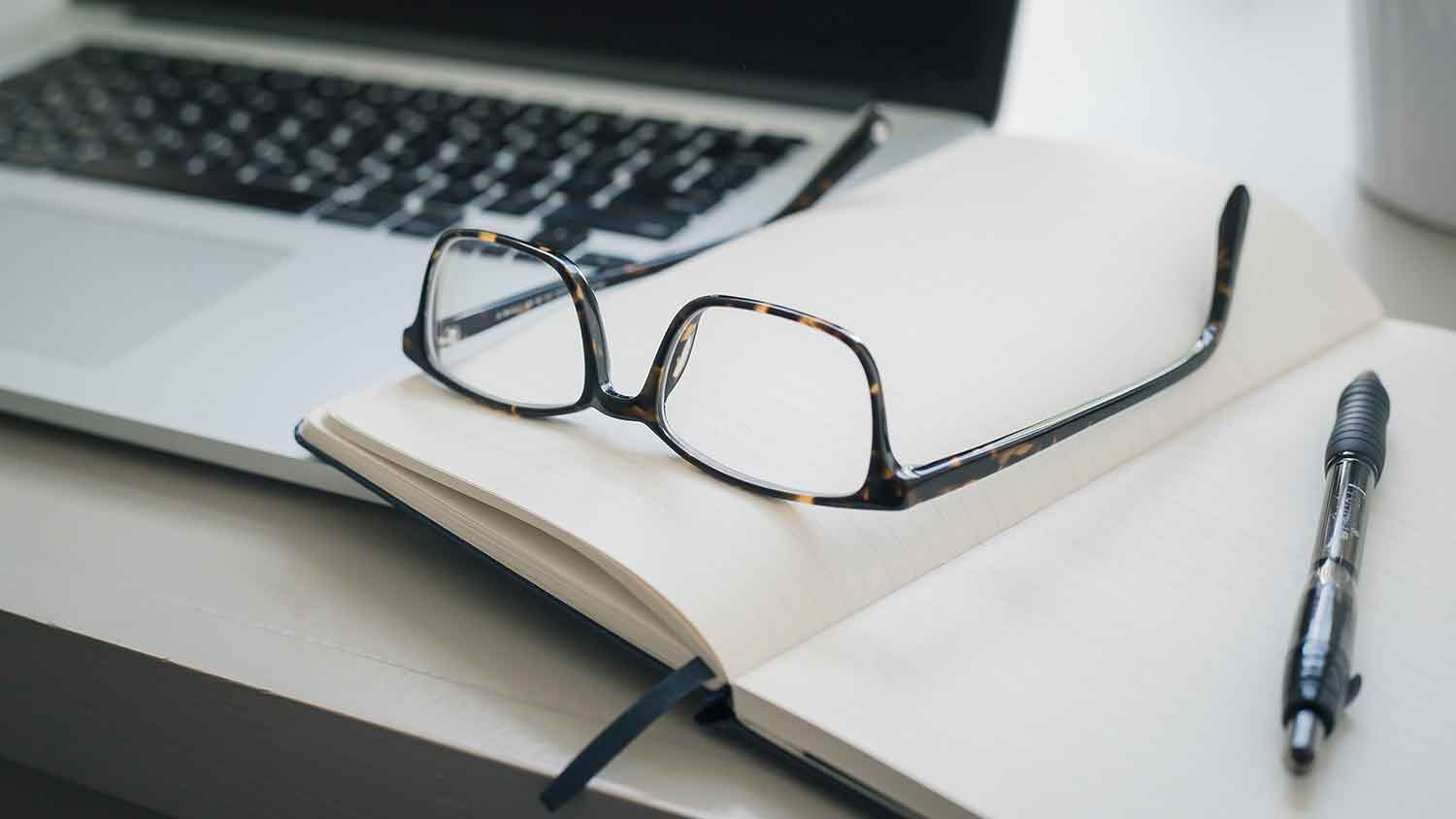 open book with glasses on top