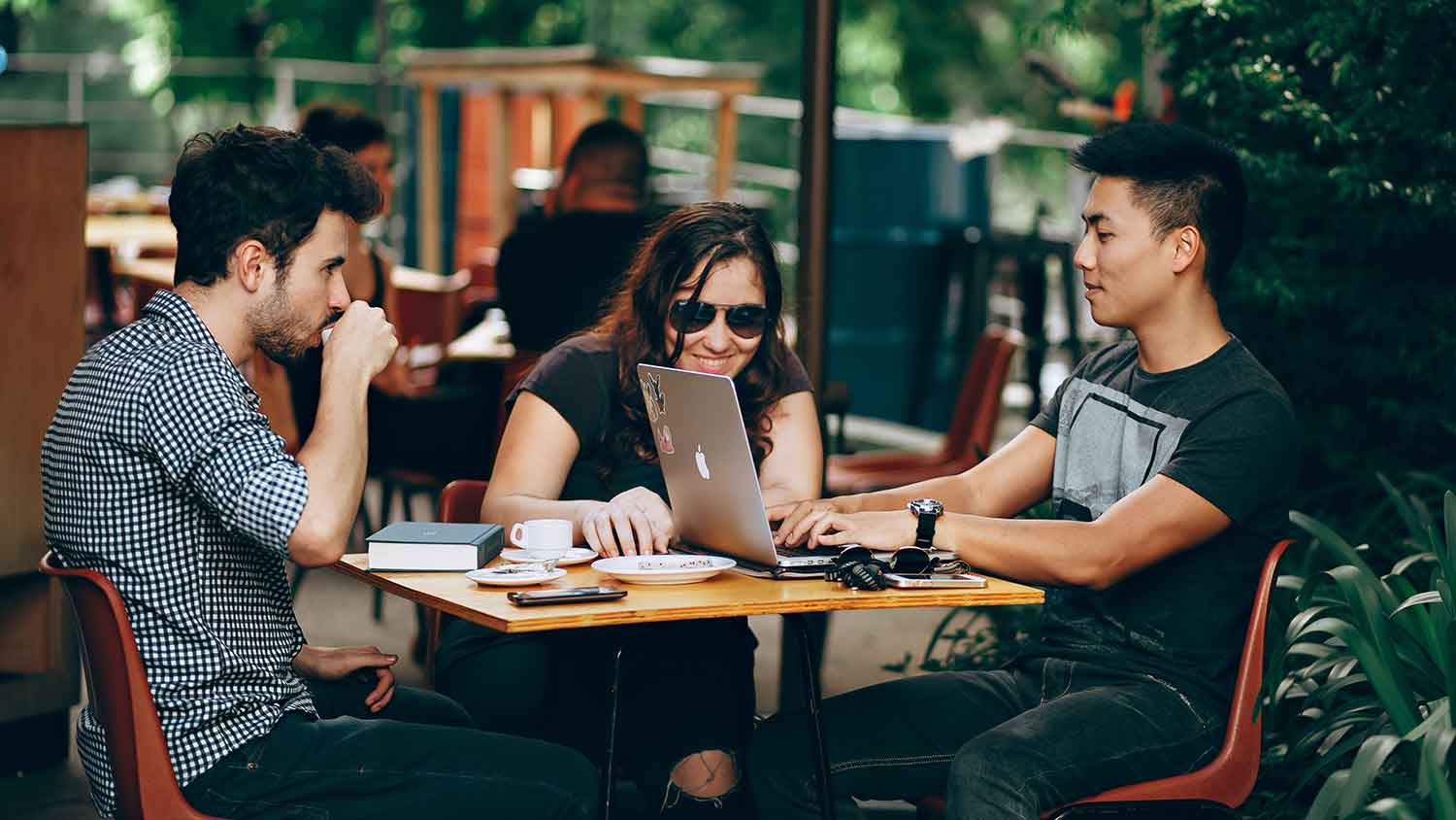 three friends at a cafe