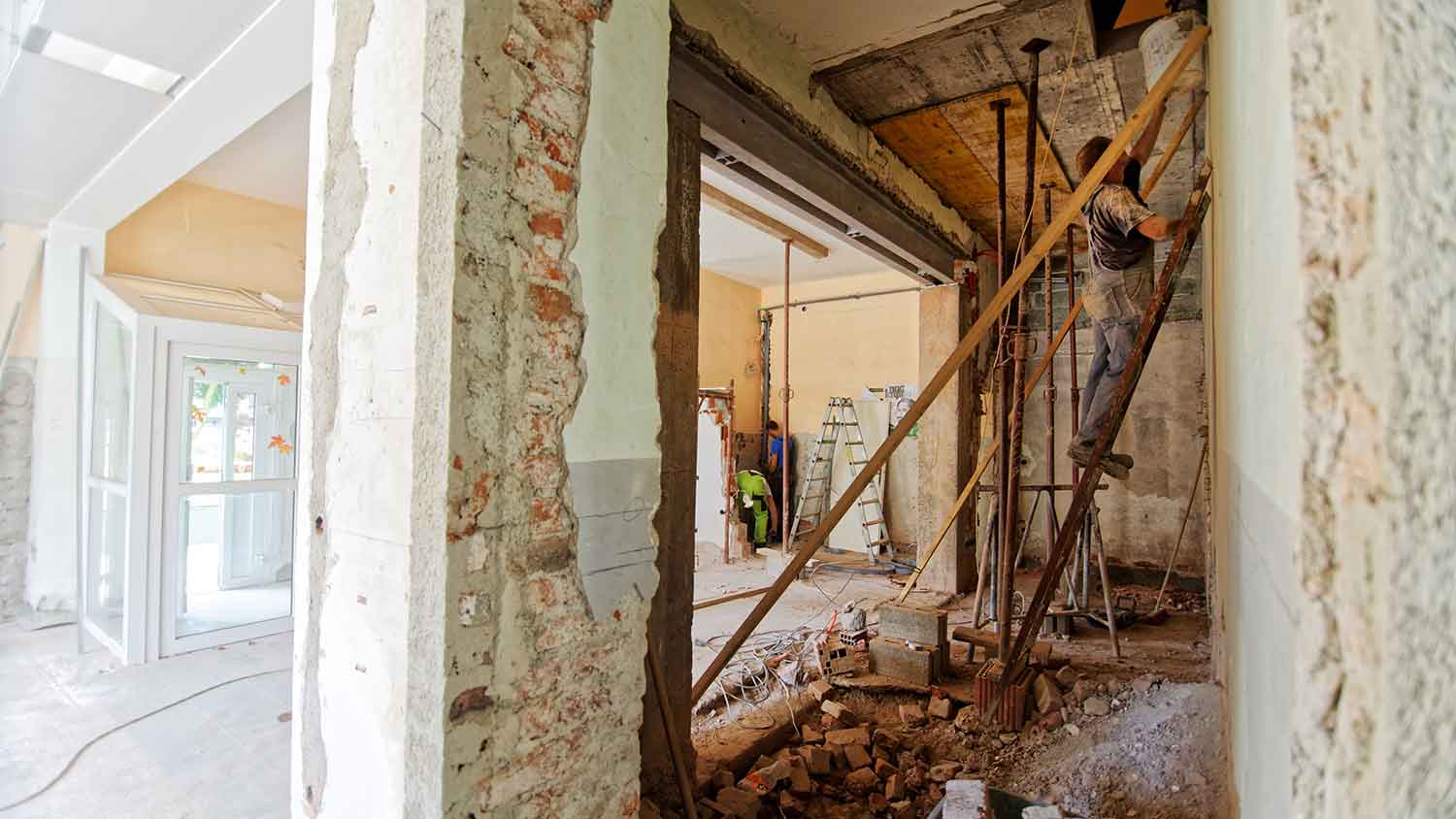man on a construction site plastering a wall